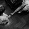 La sposa e una bambina avvicinano le loro scarpe: un gesto piccolo e spontaneo durante i preparativi.